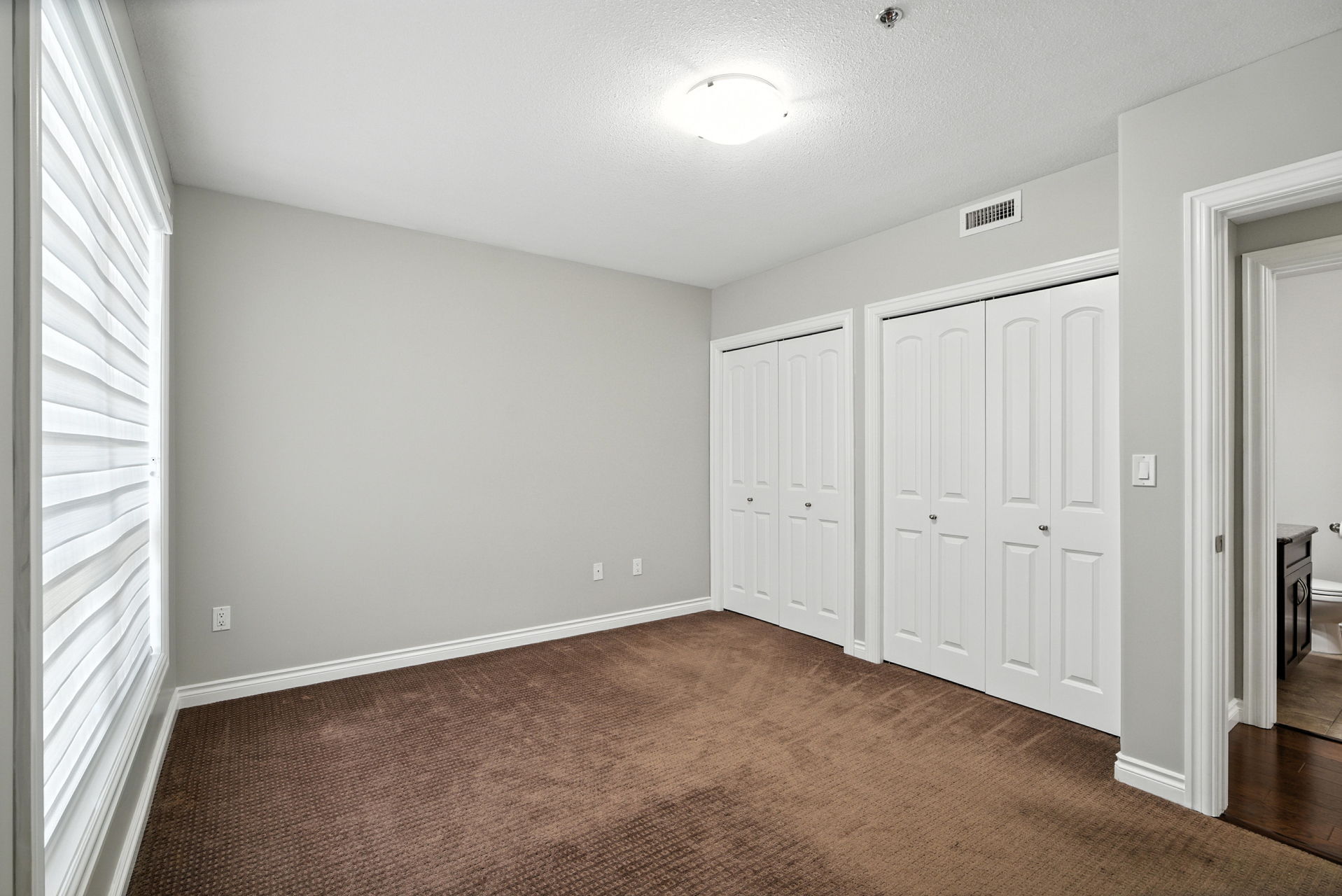 105 – 227 Pinehouse Drive bedroom with double closets